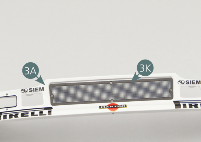 Place the air intake grille (3K) on the front bumper (3A), then position the frame (3L) on top and secure it with four MM screws.