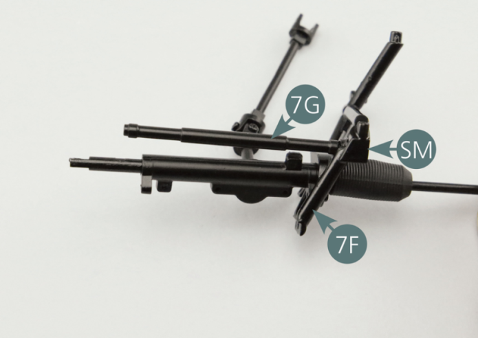 Position the steering arm (7G) on the left side frame (7F) and secure with a SM screw.