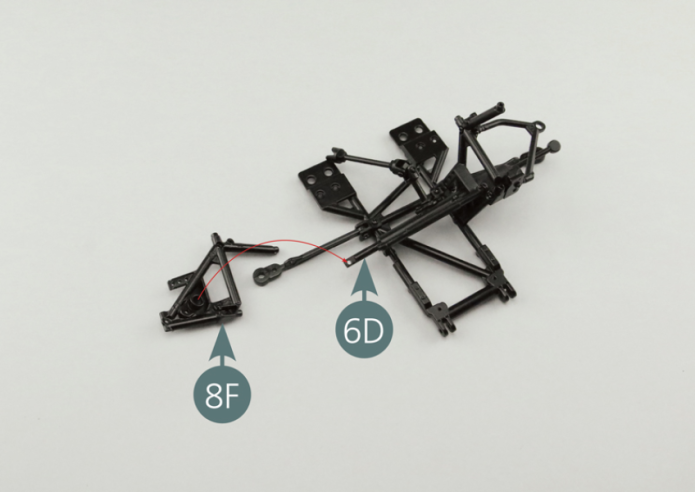 Position the steering rack casing (6F+6G) on the right side frame (8F) of the chassis, inserting the steering rack (6D) in the appropriate opening; then secure part 1 6G of the steering rack casing with an AM screw. At the same time, position the right side frame (8F) and steering damper (7G) on the bottom frame (5A) and secure with two SM screws.