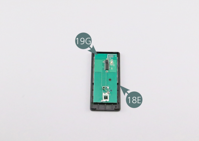 Position the PCB remote  (19G) into the front plate (18E). Close the remote control by placing the back plate (19F) onto it. 