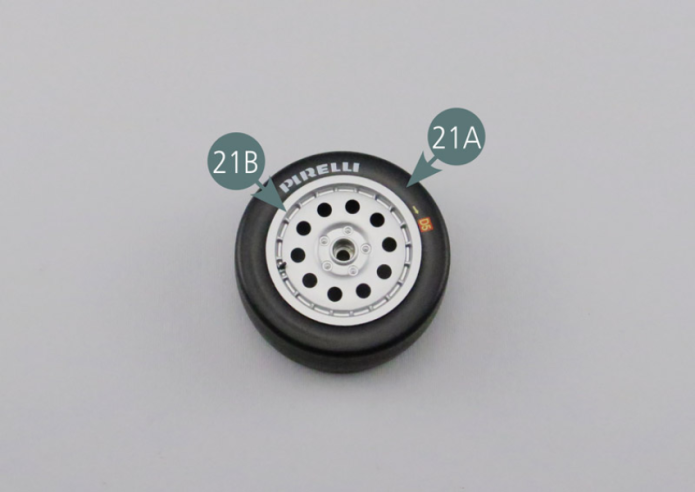 Position the outer wheel rim (21B) into the tyre (21A) - on the side with the markings. Position the inner wheel rim (21C) in the tyre (21A) aligning it with the mounting holes of the outer rim (21B), then secure with four AM screws.