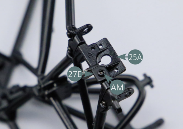 Place the right support (27E) on the right rear trapezoidal link arm (25A) and secure with an AM screw. Position the left bracket (27D) on the rear left trapezoidal link arm (24A) and secure with an AM screw.