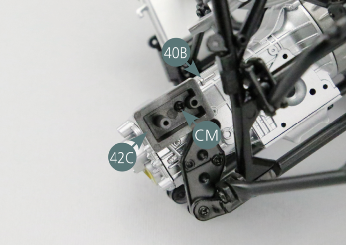 Place the gear selector housing (42C) on the right side of the gearbox (40B) and secure it with a CM screw.