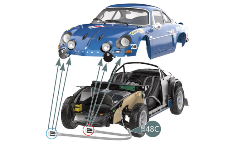 Before attaching the body to the chassis, it is necessary to install the three LED lightbulbs of the shortest part of the cable (48C) (red circle) into the headlights at the left front of the body, and the three LED lightbulbs of the longest part of the cable (48C) (blue circle) into the headlights at the right front of the body. Start by bringing the body closer to the chassis, making sure to leave sufficient distance to access the cables and connect them as explained in the following steps. Be careful not to damage the left exterior mirror and the inner door handles during assembly.