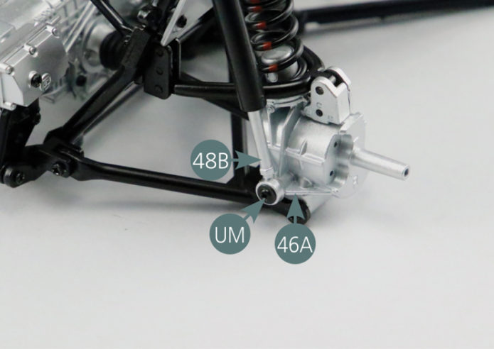 Having assembled the two shock absorbers as described above (see step 47- 1), place the first shock absorber on the right side of the engine cradle. Fix the upper end of the shock absorber cylinder (48A) to the link arm support #2 (25C) using an RP screw. Then attach the lower end of the shock absorber piston (48B) to the left rear hub (46A) using a UM screw.