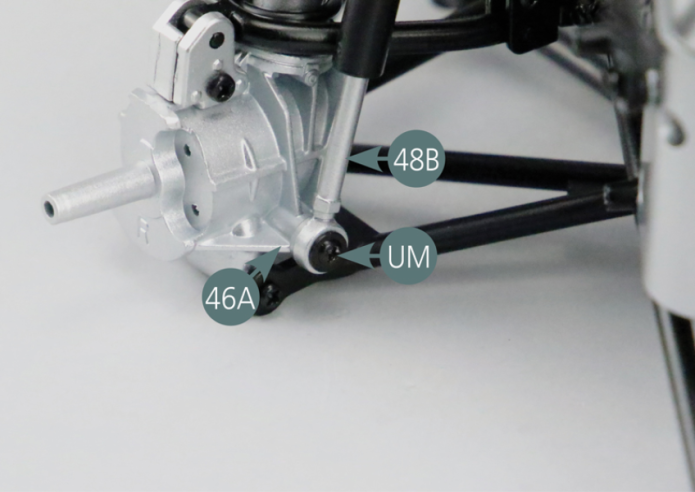 Position the second shock absorber on the engine cradle. Fix the upper end of the shock absorber cylinder (48A) to the link arm support #1 (25B) using a RP screw. Then attach the lower end of the shock absorber piston (48B) to the left rear hub (46A) using a UM screw.