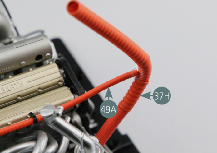 Place one end of the corrugated hose (49A) on the oil tank #6 (28F). Pass the hose (49A) through the two support brackets (49B), then connect it to air duct #2 (37H).