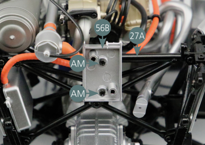 Secure the inner part of the oil radiator (56B) to the external central reinforcement (27A) with two AM screws.