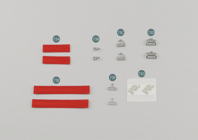 73E Correa de cinturón de seguridad ventral larga (x 2) 73F Hebilla de cierre central (x 2) 73G Adhesivo de doble cara 