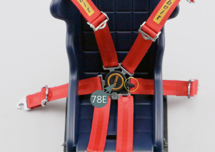 Insert the long seat belt straps (77E) onto the sides of the navigator’s seat (79A). Position the seat belt assemblies (76A, 78A, 78F and 77E) on the seat belt buckle lock (78F) as shown in the photo.Position the belt buckle lock control (78E) on the lock (78F) (check that the lever is in the correct position) and secure it from below using an SP screw.