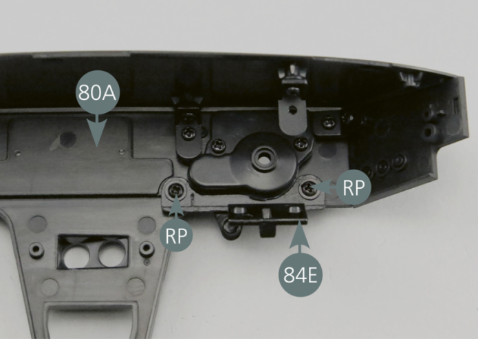 Position the lower dashboard panel plate (84E) on the rear of the dashboard panel as shown in the photo and secure it with two RP screws. Position the button (84F) on the dashboard as per picture.