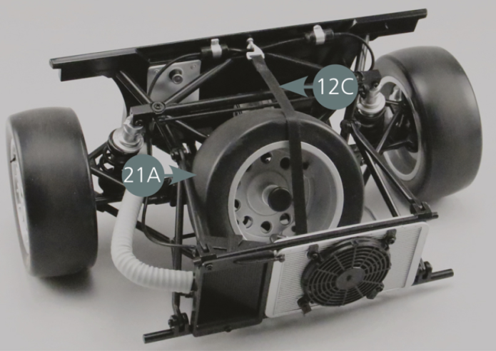 Return to the front frame assembled in the previous steps. Detach the spare wheel strap (12C) and remove the spare wheel (21A).