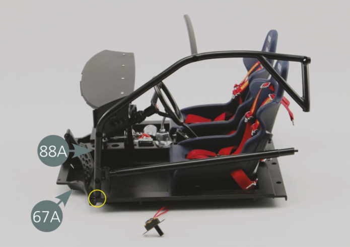 Insert the bottom end of the left roll bar safety cage (88A) into the slot in the left floor panel (67A) (indicated in yellow). Turn the assembly over and secure the cage (88A) to the floor panel (67A) with an AM screw.