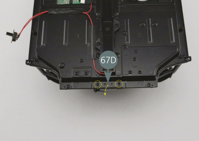 Turn the chassis over. Remove the two screws (yellow circles) securing the front joint (67D), then remove the joint as shown. Keep these items in a safe place as these will be used in a later stage.