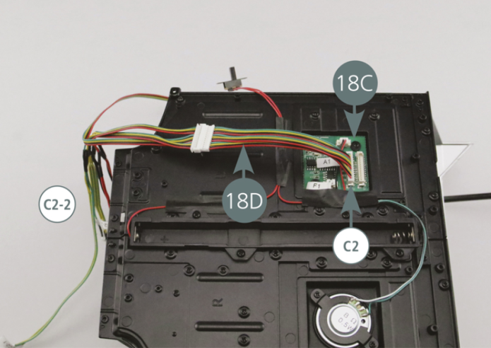 Connect the headlight cables (18D) to the C2 socket on the PCB (18C). Locate the headlight cables (18D) with the three LEDs labeled C2-2. 