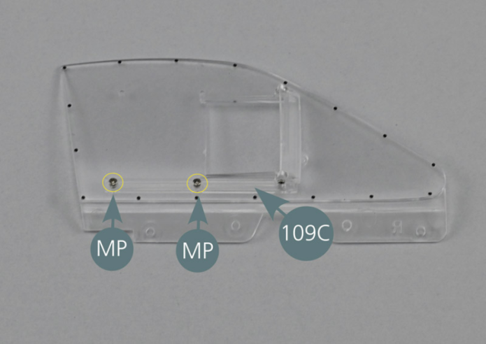 Place the lower window guide (109C) on the inside of the window (109A) ensuring that the groove is facing upwards as per picture. Center the pin located on the right of the window in the opening of the lower window guide as shown (yellow circle). While holding it in position, secure the guide (109C) from the outside of the window (109A) with two MP screws.