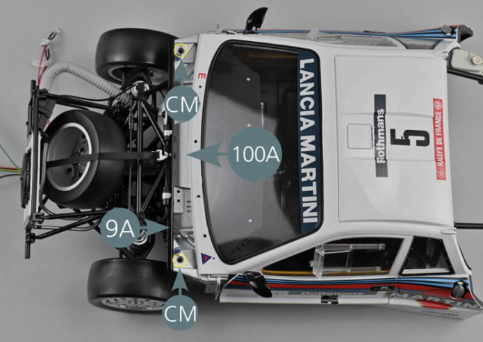 Gather the chassis and the central part of the bodywork assembled in the previous steps. Place the body (93A) on the chassis, making sure to slide the front part of the body between the front compartment bulkhead (100A) and the firewall (9A). Secure the bodywork with two CM screws in the slots located next to the front cover mounting pins (yellow circles).