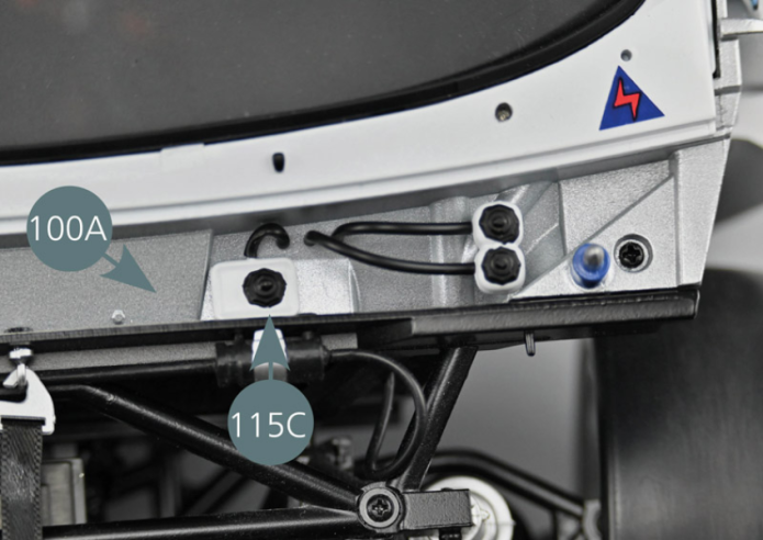 Insert one end of the 10 mm hose (115D-3) on the lug on the single expansion tank (115C). Insert the other end of the 10 mm hose (115D-3) onto the third of the three lugs located on the bulkhead front compartment (100A), as shown in the photo (yellow circle). Then position the lugs located under the single expansion tank (115C) into the two openings indicated by the yellow arrows.