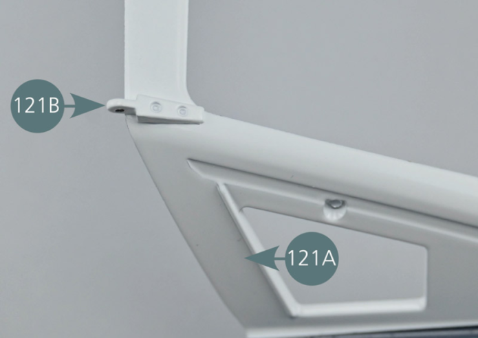 Place the left-hand hinge (121B) in the left top recess of the rear bonnet (121A). Turn the assembly over and secure the hinge with an AM screw.