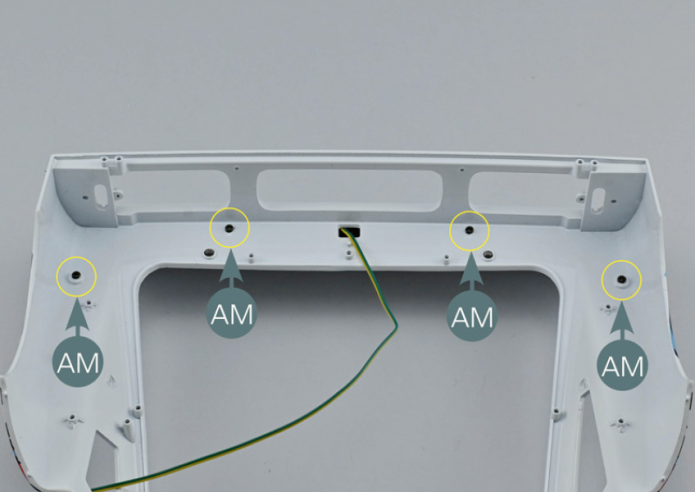 Pass the cable (19B) through the central rectangular opening in the rear bonnet (121A), working from the outside inwards. Position the rear spoiler (123A) on the rear bonnet (121A), aligning the mounting points with the corresponding openings (yellow circles). Turn the assembly over and secure the spoiler with four AM screws.