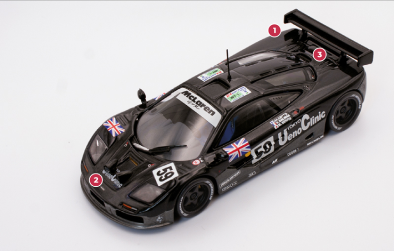 1.  Gordon Murray applied all his aerodynamic knowledge to the GTR, modifying the F1's ventilation system to control airflow resistance below the car. 2. The F1 GTR, like any other car competing in endurance races, features powerful additional lighting at the front to maintain high speeds at night.3. To comply with the 600 bhp limit imposed by the regulations at the time, the original BMW engine was forced to reduce its power by 27 bhp by limiting the air intake. The transmission featured a 6-speed dog clutch gearbox© IXO Collections SAS - Tous droits réservés. 