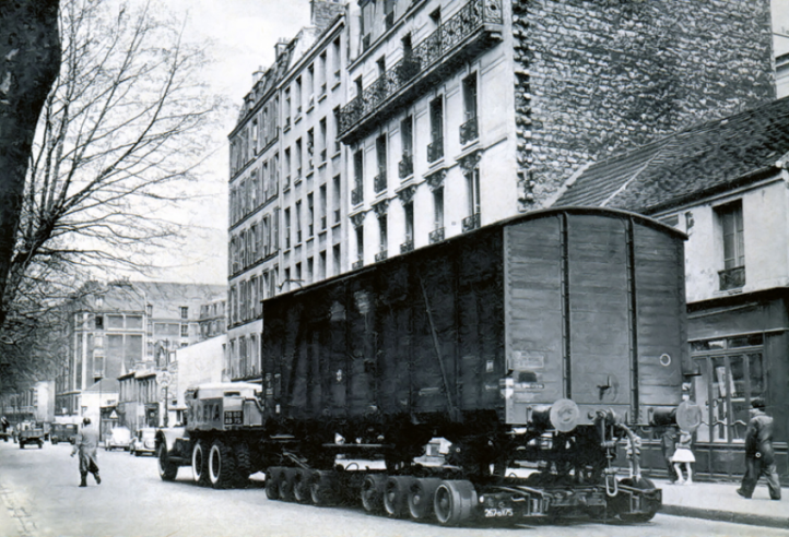 Un spectacle qui étonnerait dans le Paris cycliste actuel, mais très courant dans le Paris des années 1940 : la remorque « Porte à porte » servant à livrer directement les wagons dans les cours des usines. Le camion (ex-armée US) de la « SCETA » (filiale SNCF) fait bonne figure avec ses pneus fraîchement peints en blanc, mais roule à un prudent 10 km/h ! © IXO Collections SAS - Tous droits réservés. Crédits photo © Collection Trainsconsultant-Lamming